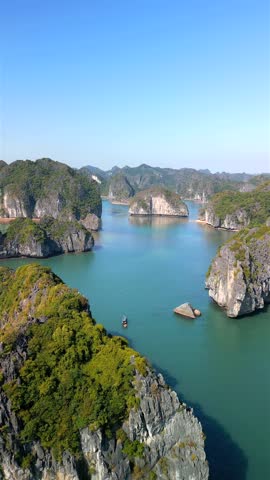 Aerial view of Ha Long Bay in Vietnam with limestone islands, emerald sea, and tropical landscape. Scenic travel destination and UNESCO World Heritage site in Southeast Asia.