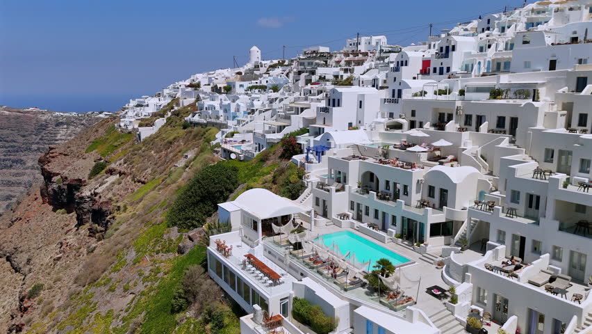 Breathtaking beauty of Santorini, with chic villas on cliffs offering stunning Aegean Sea views, alongside luxurious living options that define the essence of a perfect vacation