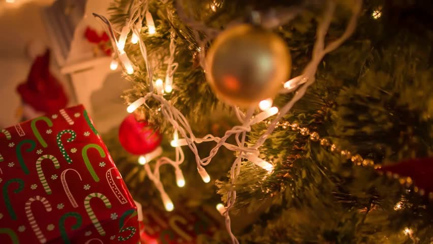 Cozy living room in Christmas style. Garlands soft light over fireplace, Christmas tree decorated red balls teddy bears with gifts. Xmas home background, celebrating winter holidays. Presents New Year