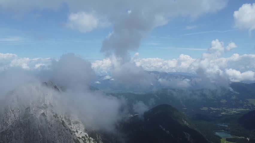 Aerial drone flight over Mangart mountain in the Julian Alps, Slovenia, capturing dramatic peaks, alpine landscape, and stunning natural scenery ideal for travel and adventure projects.