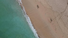 Aerial view of father and son playing soccer at the tropical beach - Powered by Shutterstock - Get 15% off with code: PIKWIZARD15