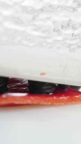 Slicing red imitation crab stick for sushi
