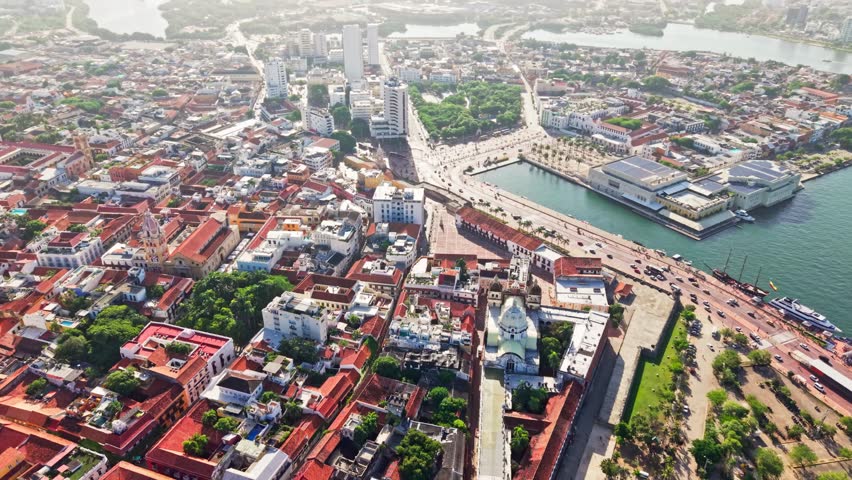 Slow motion aerial view of cartagena de indias, colombia, showcasing the cityscape, traffic and harbor