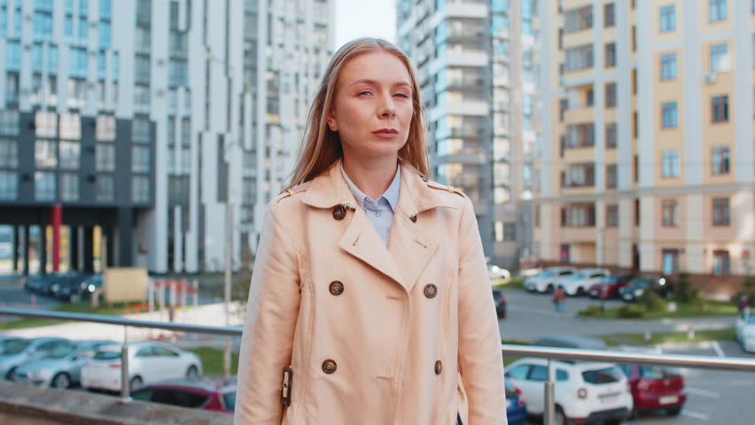 Doubtful frustrated mature businesswoman shrugging shoulders dont know answer incertitude gesture uncertain reaction on difficult question confused girl millennial feel disappointment on city street.
