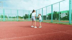 Sports Education. Full body length in action of children, little girl sisters playing basketball on a court, spending time outdoors - Powered by Shutterstock - Get 15% off with code: PIKWIZARD15