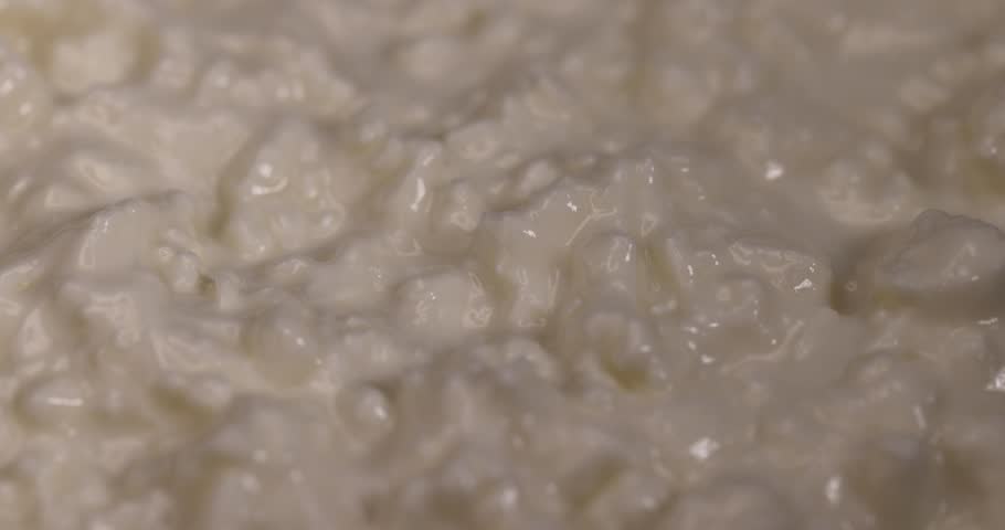 cottage cheese with sour cream and strawberries, white sour-milk cottage cheese with ripe sweet strawberries cut into pieces, close up