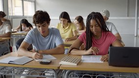 African American girl and caucasian guy students talking about class work learning together at school - Powered by Shutterstock - Get 15% off with code: PIKWIZARD15