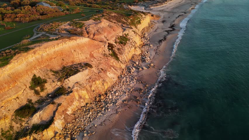 Port Willunga Beach, South Australia: 4K Aerial Drone Footage of Golden Cliffs, Golden Sand beach, Farmland Hills, Coastal Houses, Ocean Waves and Sunset Views
