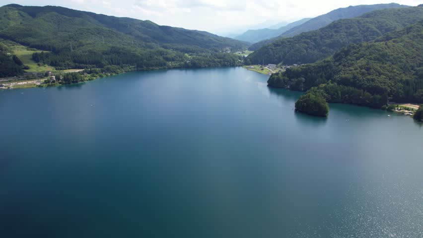 Flight Over Lake Aoki With Calm Waters In Nagano Prefecture, Japan - Drone Shot