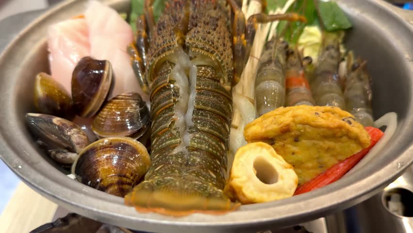 Lobster Nabe, Lobster served hot with vegetables in a pot, Lobster served in hot pot meal with vegetables and meat