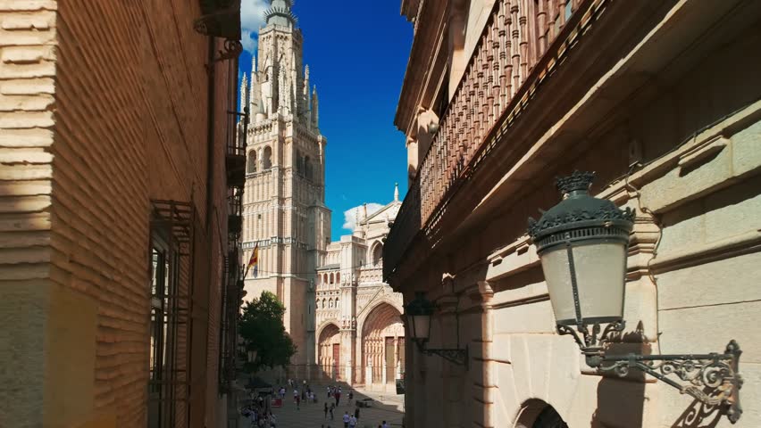 Magnificent historic facade of the Cathedral of Saint Mary of Toledo in Castilla-La Mancha, Spain. Impressive Gothic building in the heart of the Toledo old town. Slow motion steadicam footage