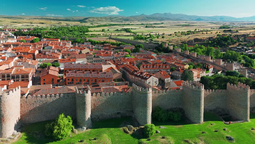 Aerial view of the medieval stone walls surrounding the historic city of Avila, Spain. Scenic drone view of Avila old town, a prime example of medieval architecture and a UNESCO World Heritage Site.