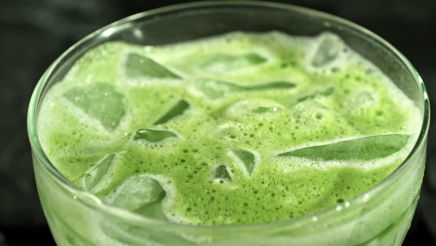 Super Slow Motion Detail Shot of Pouring Cream into Matcha Latte with Camera Motion at 1000fps.