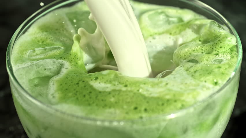 Super Slow Motion Detail Shot of Pouring Cream into Matcha Latte with Camera Motion at 1000fps.