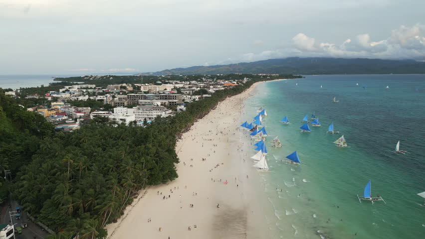 Cinematic aerial footage showcase a natural sandy beach on western coast of Boracay island, Philippines.