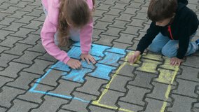 Children Draws With Chalk on Pavement Drawing of Big Ukrainian Flag. Little Girl and Boy Drawing Ukrainian Flag With Chalk. Crisis, Peace, Stop Aggression, Children Against War. Freedom to Ukraine. - Powered by Shutterstock - Get 15% off with code: PIKWIZARD15