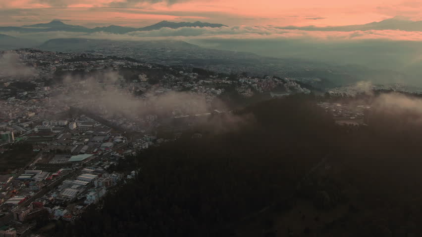 Breathtaking sunrise view over hilly landscape with clouds covering hills