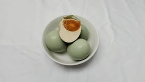 Footage. Salted blue duck eggs are placed on a white bowl. Salted duck egg processed food. Dishes made from eggs that are preserved by salting. - Powered by Shutterstock - Get 15% off with code: PIKWIZARD15