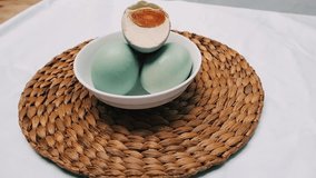 Footage. Salted blue duck eggs are placed on a white bowl. Salted duck egg processed food. Dishes made from eggs that are preserved by salting. - Powered by Shutterstock - Get 15% off with code: PIKWIZARD15