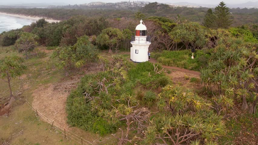 Aerial views of Fingal Head Lighthouse with the causeway rock formations below in Fingal Head, New South Wales, Australia