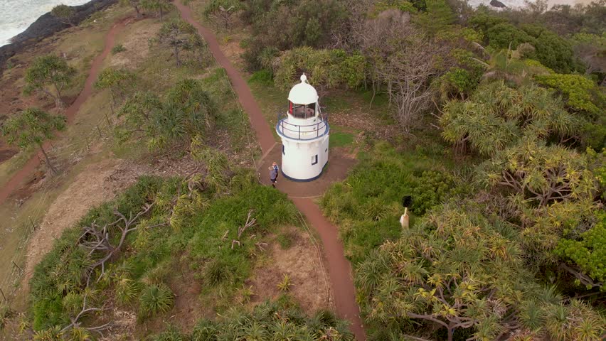 Aerial views of Fingal Head Lighthouse with the causeway rock formations below in Fingal Head, New South Wales, Australia