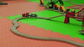 Child Plays With Colorful Wooden Train Set on Vibrant Play Mat in Bright Indoor Space - Powered by Shutterstock - Get 15% off with code: PIKWIZARD15
