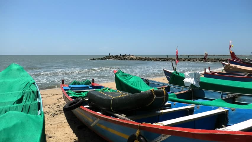 Fishing boats moored on the beach at Chethy, Alappuzha, Kerala, India.