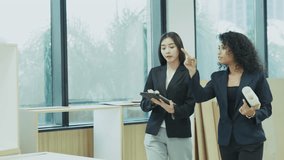 Female architects analyzing blueprint together at office desk, concept of teamwork, construction project planning, design collaboration and professional work - Powered by Shutterstock - Get 15% off with code: PIKWIZARD15
