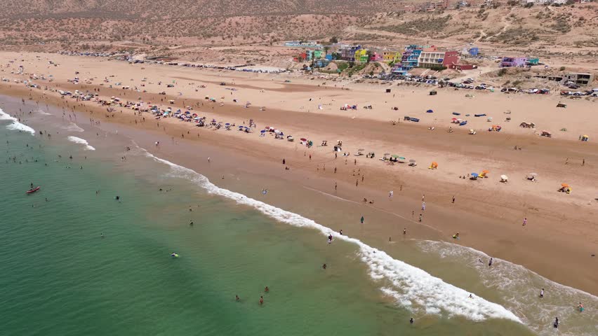 Aerial drone view of Aghroud Beach in Morocco, with its colorful seaside houses and picturesque coastline
