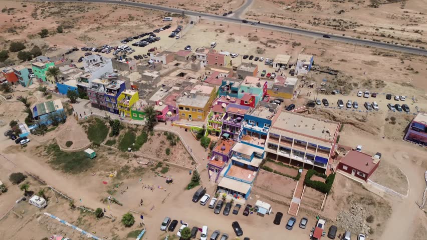 Aerial drone view of Aghroud Beach in Morocco, with its colorful seaside houses and picturesque coastline.