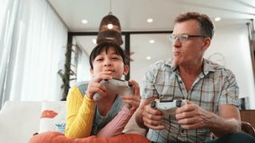 Granddaughter teaching grandfather play console game, entertainment hobby. Old senior use technology communicate with new generation kid cross generation gap strengthen family bond. Divergence. - Powered by Shutterstock - Get 15% off with code: PIKWIZARD15