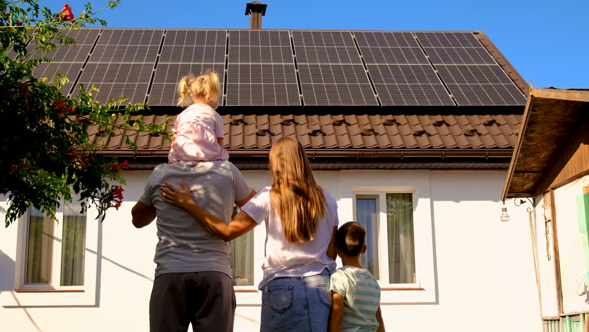 Family looking at solar panels. Selective focus. Sun.