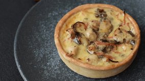 Pie or quiche, a sour tart with chicken and mushrooms, spices and herbs on a dark concrete background. Round quiche with chicken - Powered by Shutterstock - Get 15% off with code: PIKWIZARD15