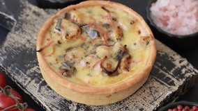 Pie or quiche, a sour tart with chicken and mushrooms, spices and herbs on a dark concrete background. Round quiche with chicken - Powered by Shutterstock - Get 15% off with code: PIKWIZARD15
