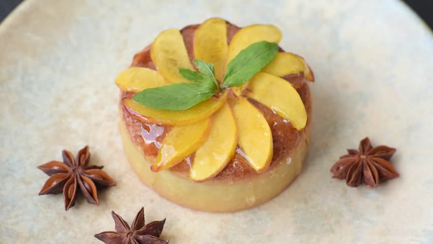 Sweet round pie or tart with apples and peach, cream and nuts. Mini sweet tart with fruit slices