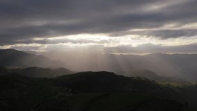 Sunlight creates stunning crepuscular rays over green valleys and mountains in cantabria, spain - Powered by Shutterstock - Get 15% off with code: PIKWIZARD15