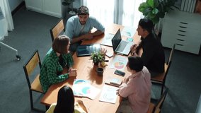Top view of caucasian businessman present marketing plan by show financial graph to diverse investor to make decision for investment. Diverse business people discussion about smart plan. Convocation. - Powered by Shutterstock - Get 15% off with code: PIKWIZARD15