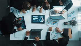 Top view of smart business people brainstorm marketing idea at meeting table while compare stock market investment data between laptop and tablet. Business team planning financial plan. Directorate. - Powered by Shutterstock - Get 15% off with code: PIKWIZARD15