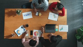 Top down view of manager holds tablet display increasing sales and placed on meeting table. Group of diverse business team clapping hands to celebrate successful product at meeting room Convocation. - Powered by Shutterstock - Get 15% off with code: PIKWIZARD15