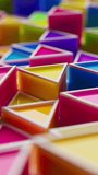 Looped animation of colorful plastic triangular shapes in soft focus. Bright, playful, toy-like geometry moves up and down seamlessly. Ideal for kids, motion backgrounds, or abstract themes. - Powered by Shutterstock - Get 15% off with code: PIKWIZARD15