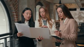 Multiracial three business women diversity girls females businesswomen holding documents teamwork partnership talking discussing marketing financial result with laptop brainstorming meeting in office - Powered by Shutterstock - Get 15% off with code: PIKWIZARD15