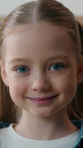 Close up portrait Caucasian happy little girl smiling looking at camera at home kitchen family good relationship custody adopted cute kid daughter posing indoors child schoolgirl smile face positive
