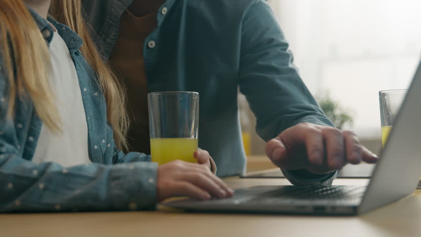 Caucasian happy family bonding at kitchen with glass of juice cute girl daughter child kid with daddy using computer together parental control e-learning at home father parenting helping with laptop - Powered by Shutterstock - Get 15% off with code: PIKWIZARD15