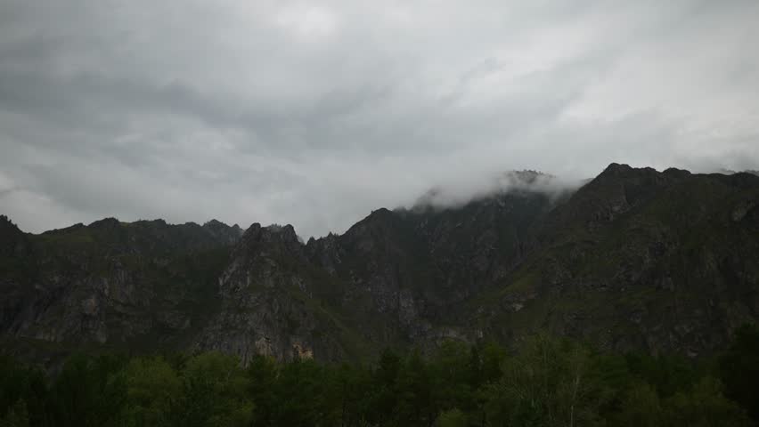 Dark Clouds Over Pine Forest Mountains