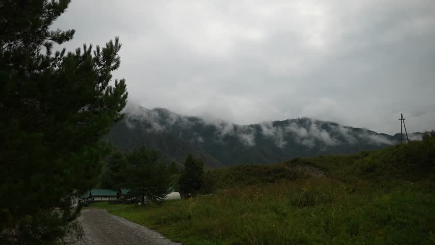 Dark Clouds Over Pine Forest Mountains