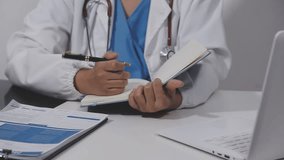 Female doctor working on laptop computer searching the information and using digital tablet at doctor's office. Medical student using computer, healthcare and medicine concept - Powered by Shutterstock - Get 15% off with code: PIKWIZARD15