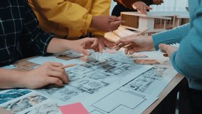 A vibrant scene capturing a collaborative design session where creative professionals engage with architectural plans and materials, fostering innovation and teamwork. SACTR - Powered by Shutterstock - Get 15% off with code: PIKWIZARD15