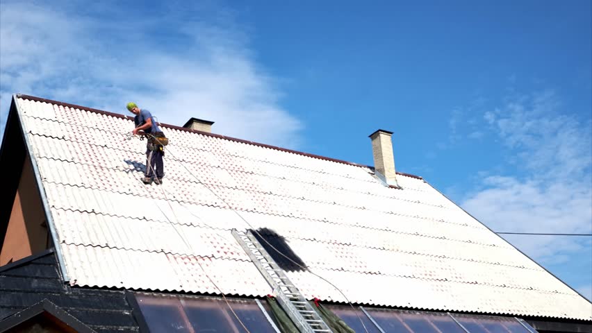 Timelapse, A Man Spray Painting a Roof on a Rope