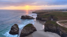 Drone shot of the Playa de Las Catedrales beach at sunrise, Galicia region, northern Spain. Beautiful cliffs on famous Cathedral Beach, Cantabrian Coast . High quality 4k footage - Powered by Shutterstock - Get 15% off with code: PIKWIZARD15