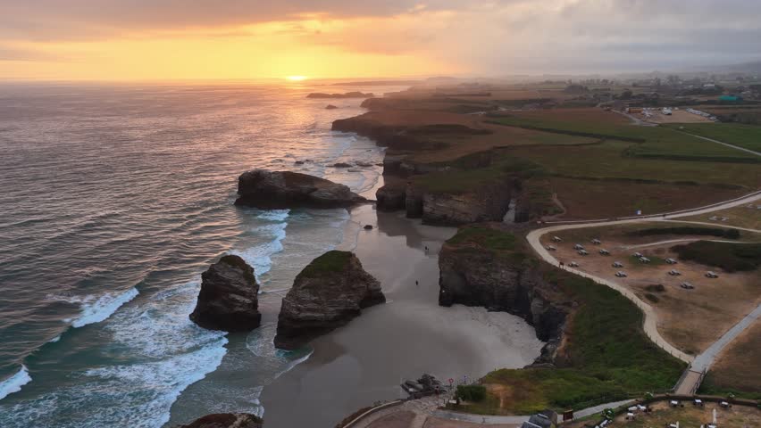 sunrise on the coast of Galicia in northern Spain, Playa de Las Catedrales beach in Galicia, tourism in northern Spain. Beautiful cliffs on famous Cathedral Beach, Cantabrian Coast 